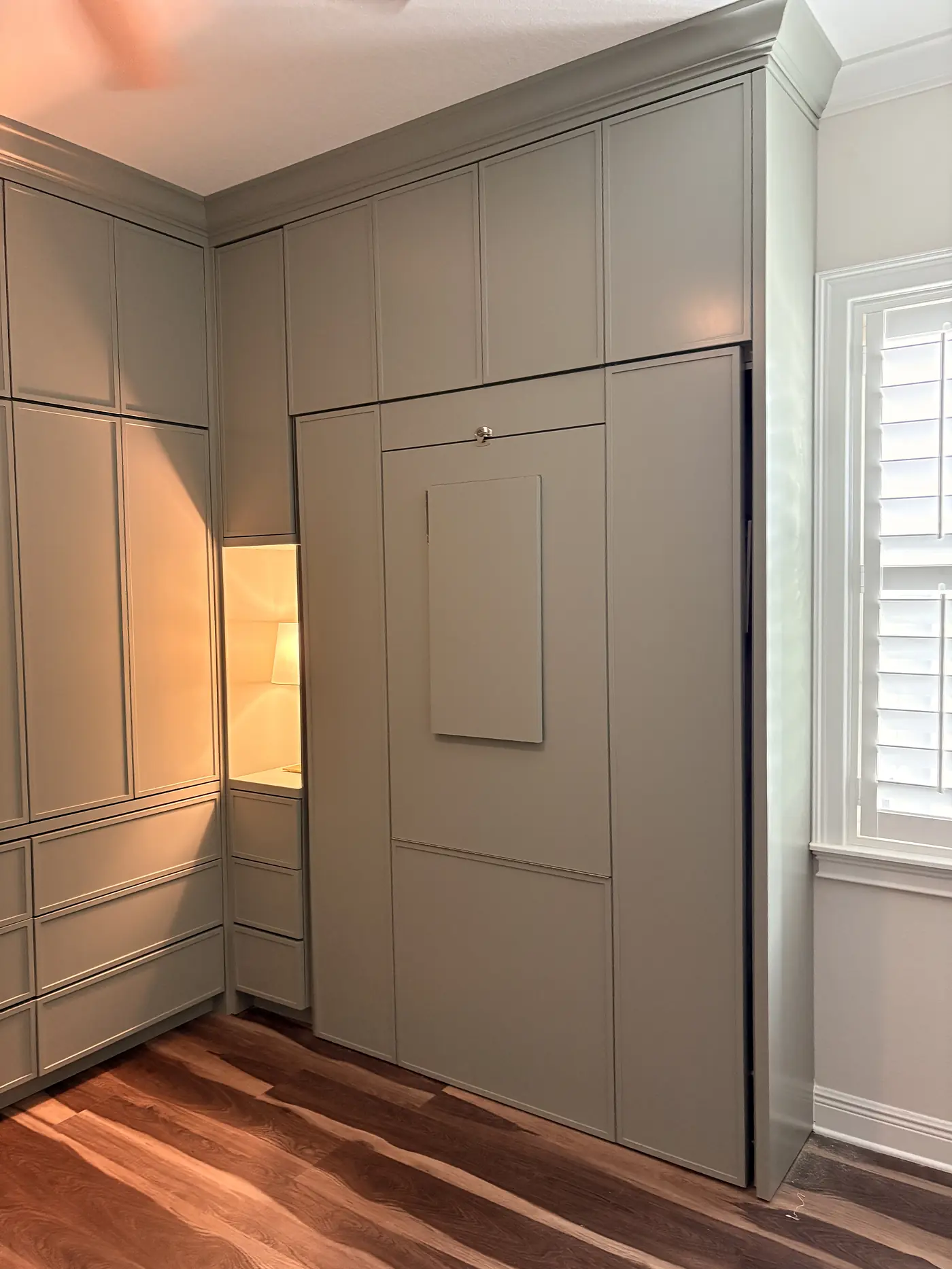 Panelled wall with a concealed door standing open
